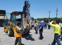 Image of tractor and maintenance operators